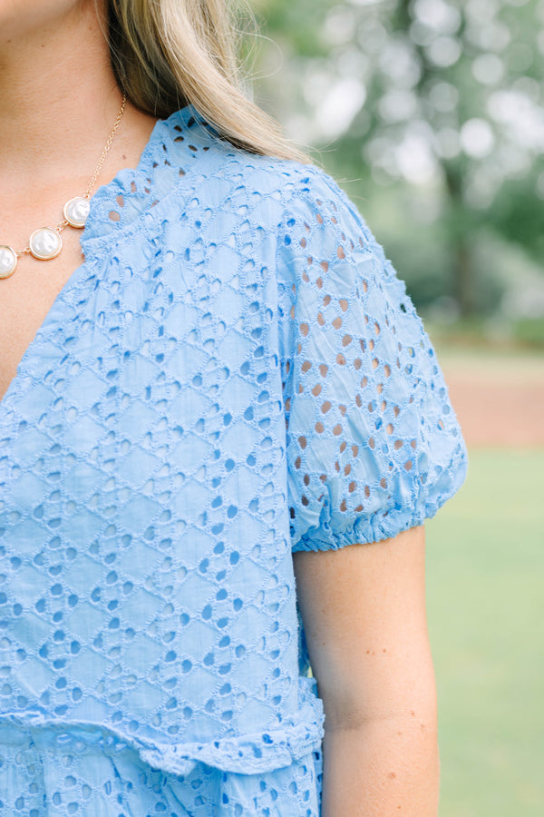 Plus Size blue eyelet babydoll top with short puff sleeves, V-neckline, and button-front detail.