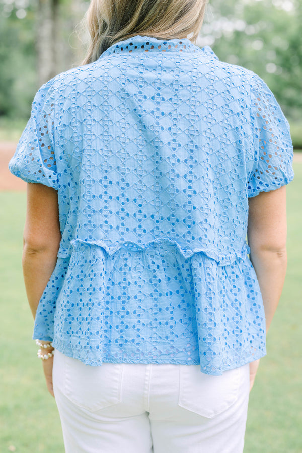 Plus Size blue eyelet babydoll top with short puff sleeves, V-neckline, and button-front detail.