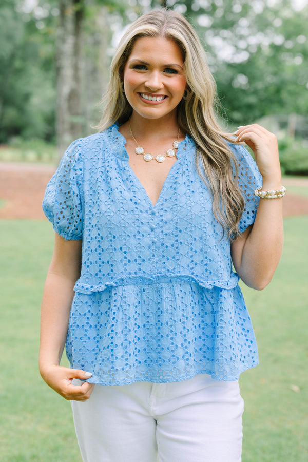 Plus Size blue eyelet babydoll top with short puff sleeves, V-neckline, and button-front detail.