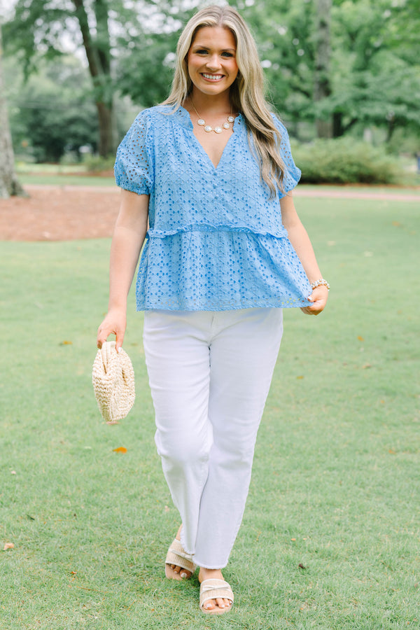 Plus Size blue eyelet babydoll top with short puff sleeves, V-neckline, and button-front detail.