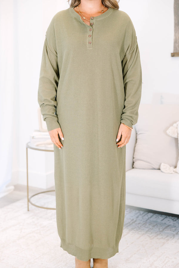 Plus size olive green midi dress with long sleeves, button neckline, and a brown belt.