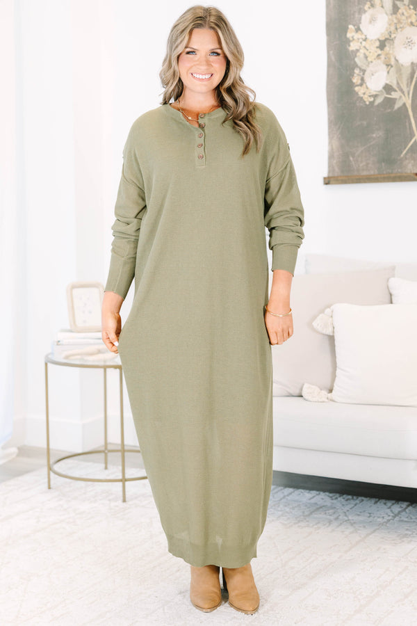 Plus size olive green midi dress with long sleeves, button neckline, and a brown belt.