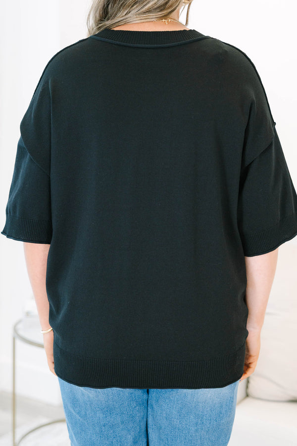 Plus size black short sleeve sweater with a flowy fit and ribbed hem
