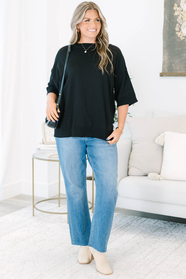 Plus size black short sleeve sweater with a flowy fit and ribbed hem