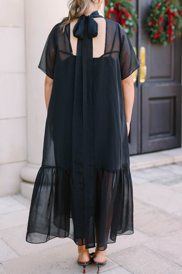 Plus Size black midi dress with a high neck, sheer overlay, short sleeves, and a ruffled hem.
