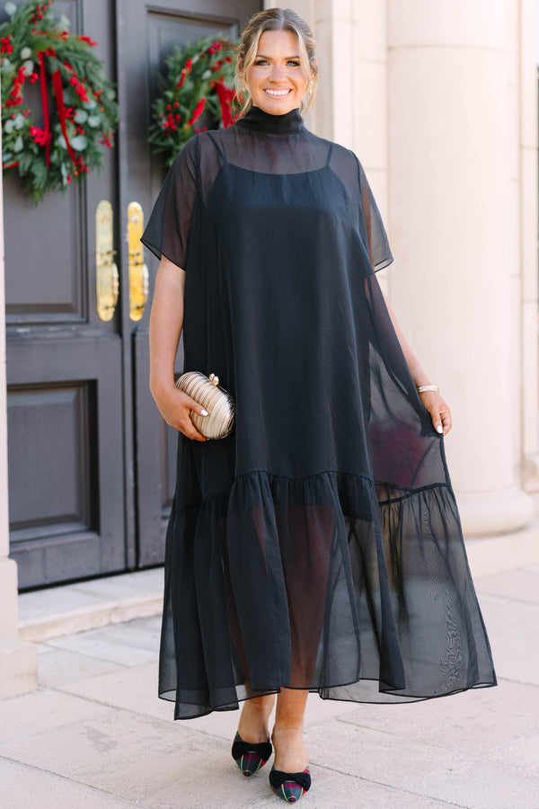 Plus Size black midi dress with a high neck, sheer overlay, short sleeves, and a ruffled hem.