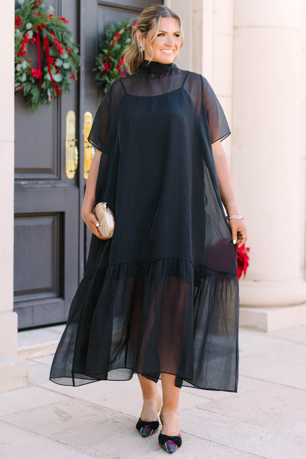 Plus Size black midi dress with a high neck, sheer overlay, short sleeves, and a ruffled hem.