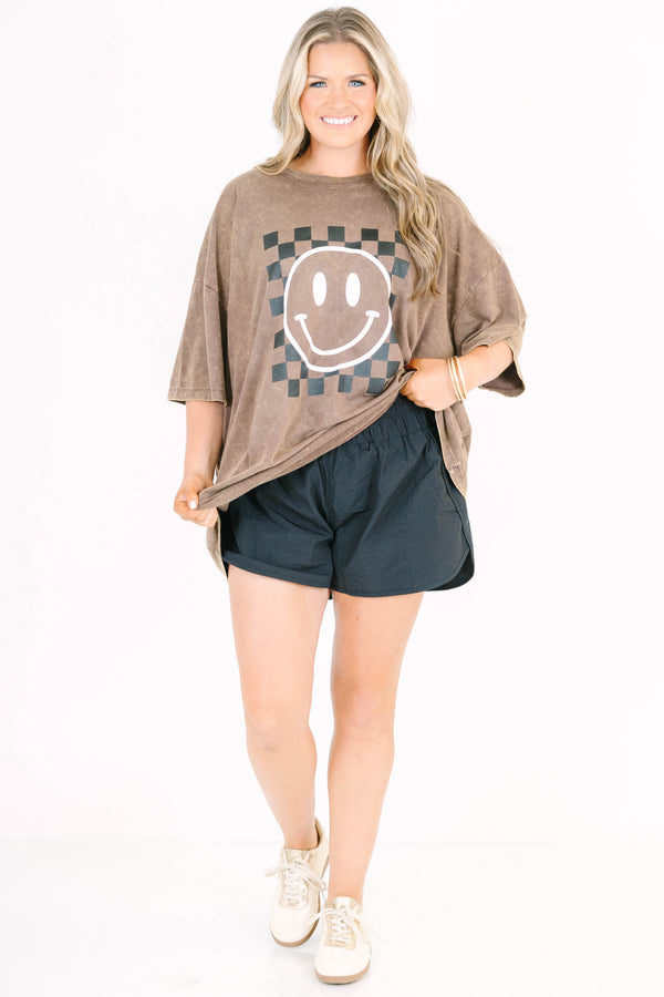 Plus Size mahogany acid wash relaxed tee with a checkered smiley face graphic and black shorts.
