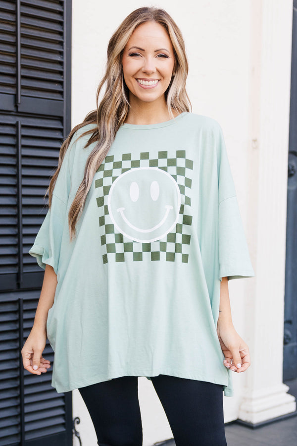 Chic Soul plus size clothing, light green faded teal colored oversized tee with smiley face graphic in military green