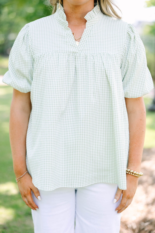 Plus Size green and white gingham top with puff sleeves, a ruffled collar, and a split neckline.