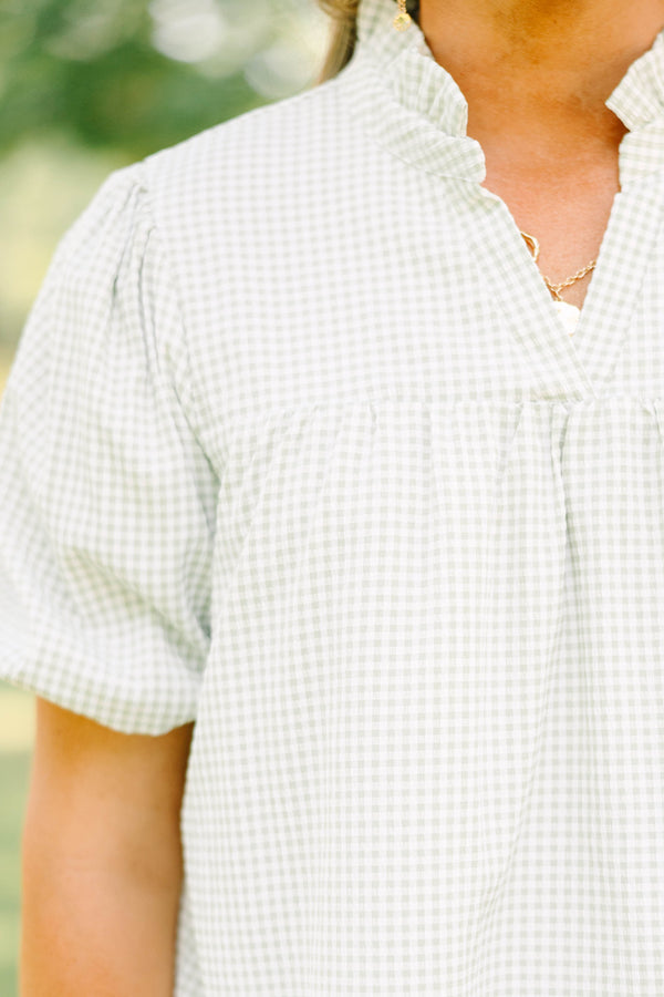 Plus Size green and white gingham top with puff sleeves, a ruffled collar, and a split neckline.