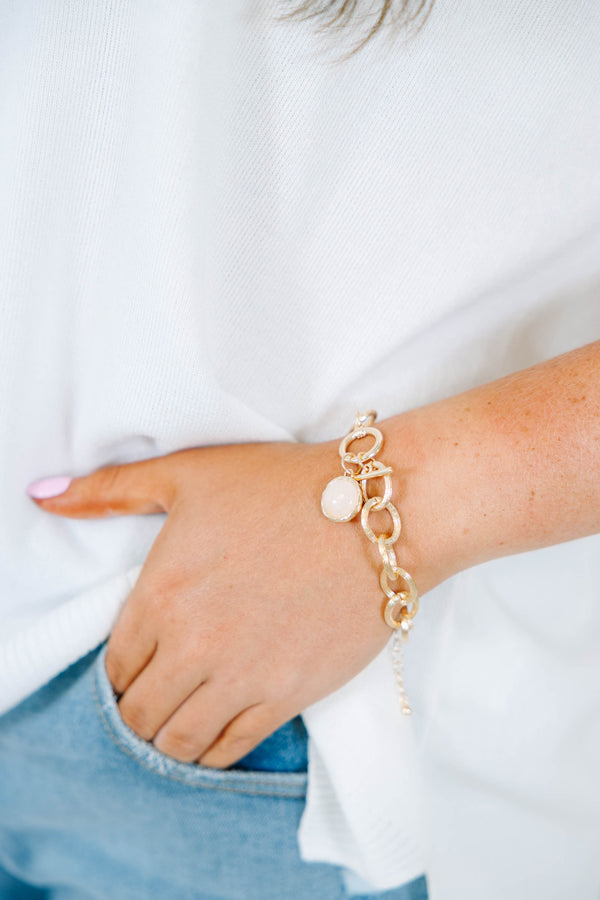 Plus Size gold chain link bracelet with a round white stone charm and toggle closure.