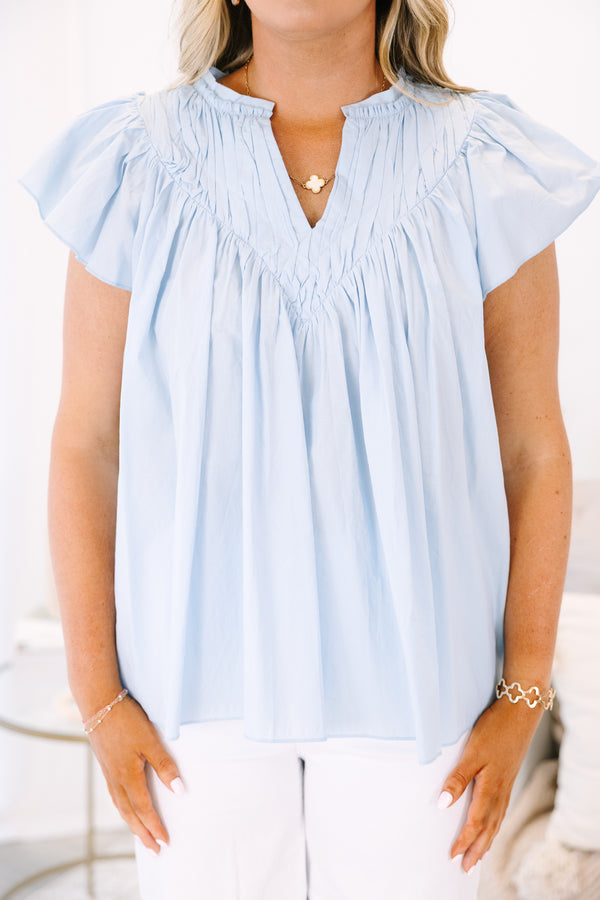 Plus Size light blue babydoll top with flutter sleeves, a v-neckline, and pleated bodice.