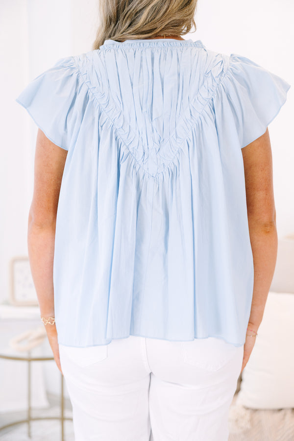 Plus Size light blue babydoll top with flutter sleeves, a v-neckline, and pleated bodice.