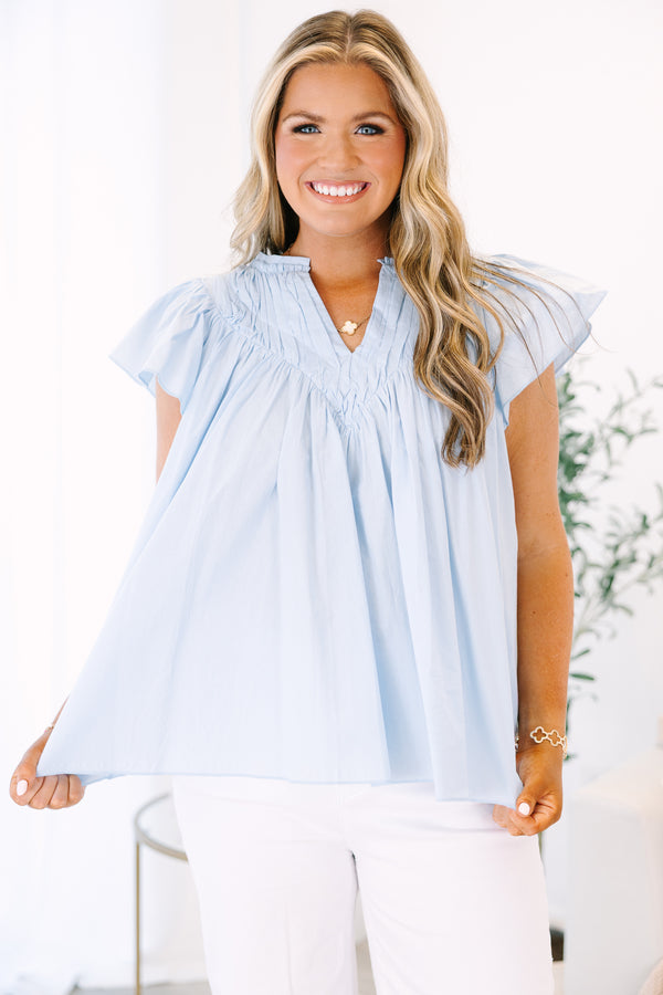 Plus Size light blue babydoll top with flutter sleeves, a v-neckline, and pleated bodice.