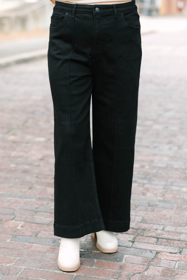 Plus Size black high-rise wide-leg jeans with front pintuck detailing and a relaxed fit.