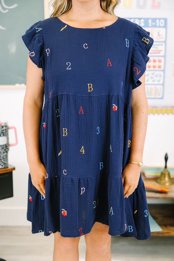 Plus Size navy babydoll dress with flutter sleeves and colorful embroidered letters and numbers.