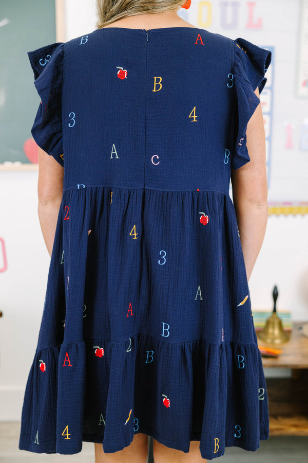 Plus Size navy babydoll dress with flutter sleeves and colorful embroidered letters and numbers.