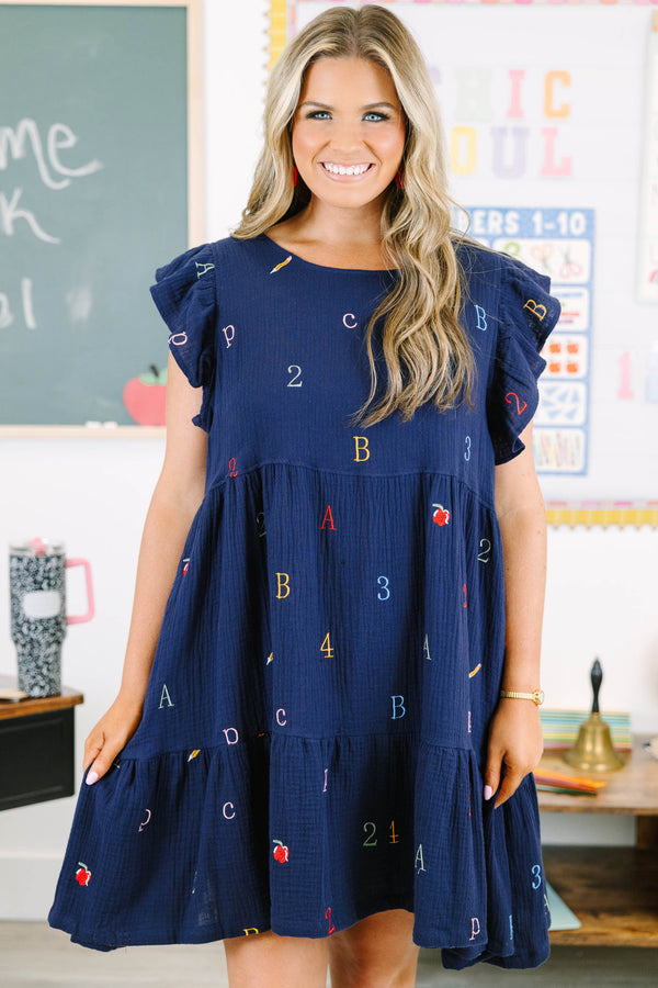Plus Size navy babydoll dress with flutter sleeves and colorful embroidered letters and numbers.