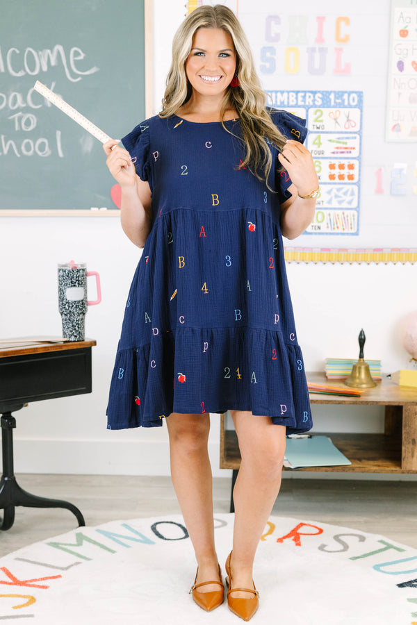 Plus Size navy babydoll dress with flutter sleeves and colorful embroidered letters and numbers.