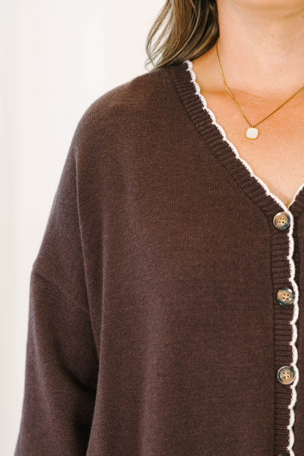 Plus Size brown oversized knit cardigan with white scalloped trim, V-neckline, and button front.