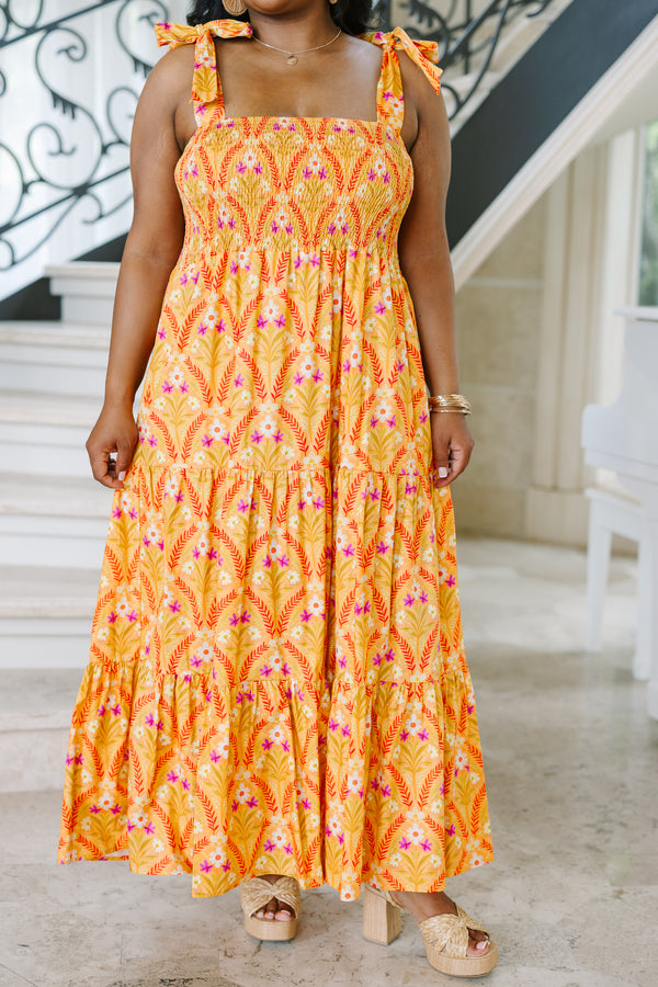 Plus Size orange floral tiered maxi dress with a smocked bodice and tie-shoulder straps.