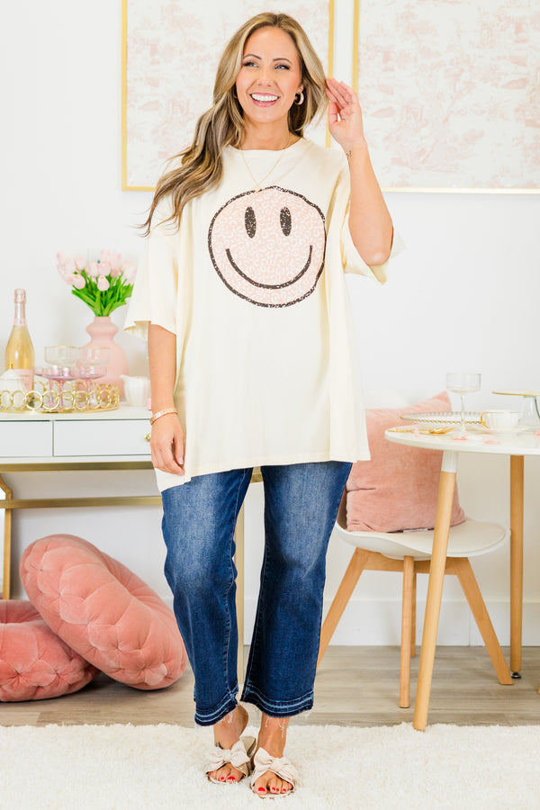 Chic Soul plus size clothing, short-sleeve ivory boyfriend tee with high-scoop-neckline and graphic art of a smiley face with pink leopard print pattern outlined with black sparkles