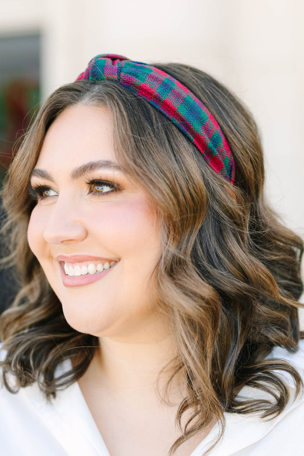 Plus size woman wearing a red and green Plaid Promise Headband with a top knot detail.