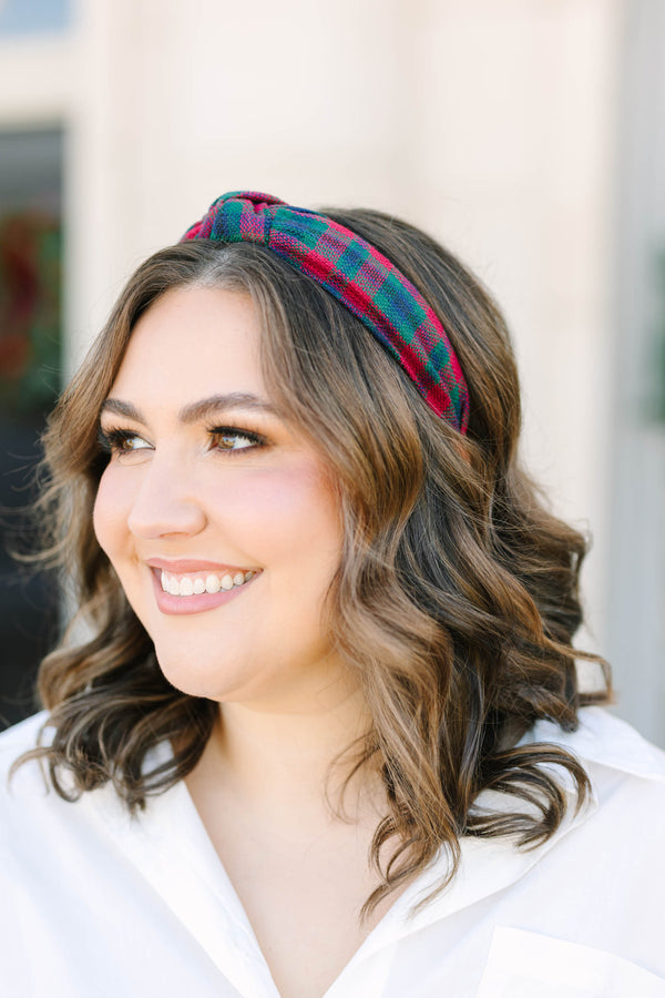 Plus size woman wearing a red and green Plaid Promise Headband with a top knot detail.