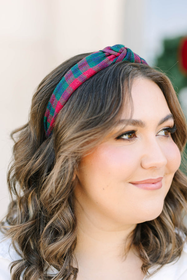 Plus size woman wearing a red and green Plaid Promise Headband with a top knot detail.