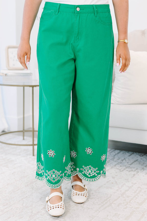Plus Size green wide-leg jeans with a high-rise waist and white floral eyelet scalloped hems.