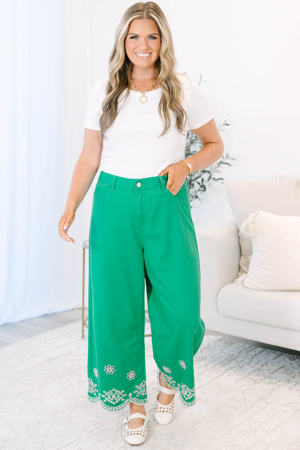 Plus Size green wide-leg jeans with a high-rise waist and white floral eyelet scalloped hems.