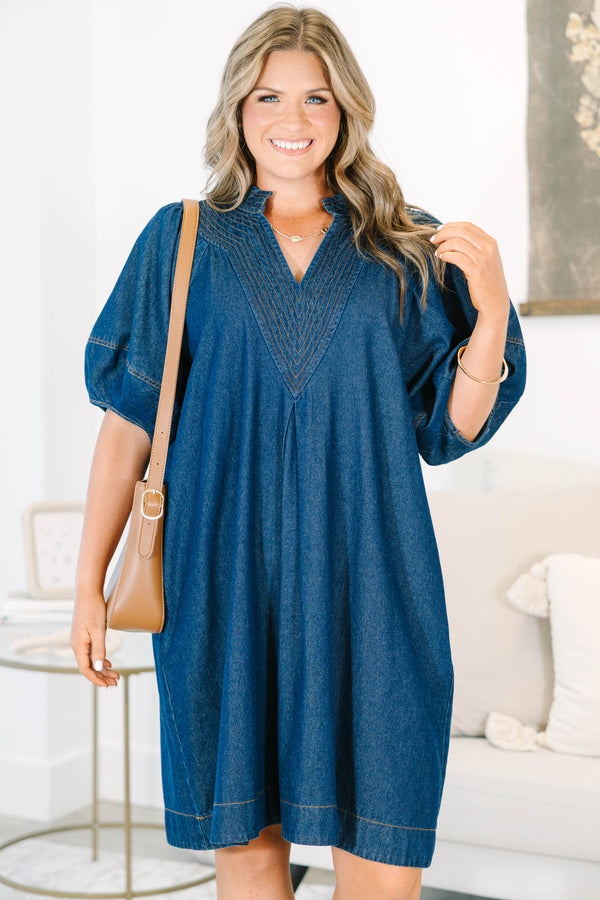 Plus Size dark denim dress with a V-neckline, decorative stitching, and short puff sleeves.