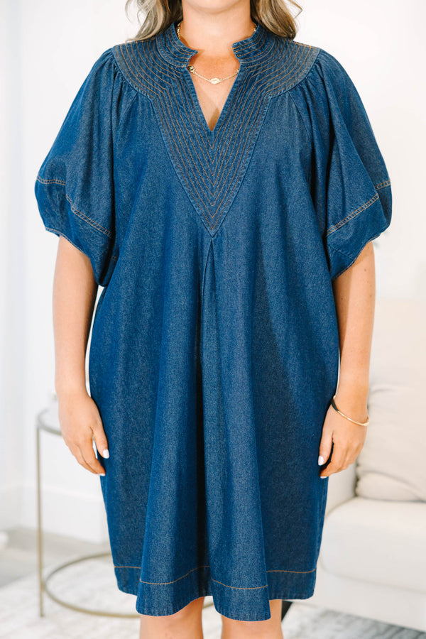 Plus Size dark denim dress with a V-neckline, decorative stitching, and short puff sleeves.
