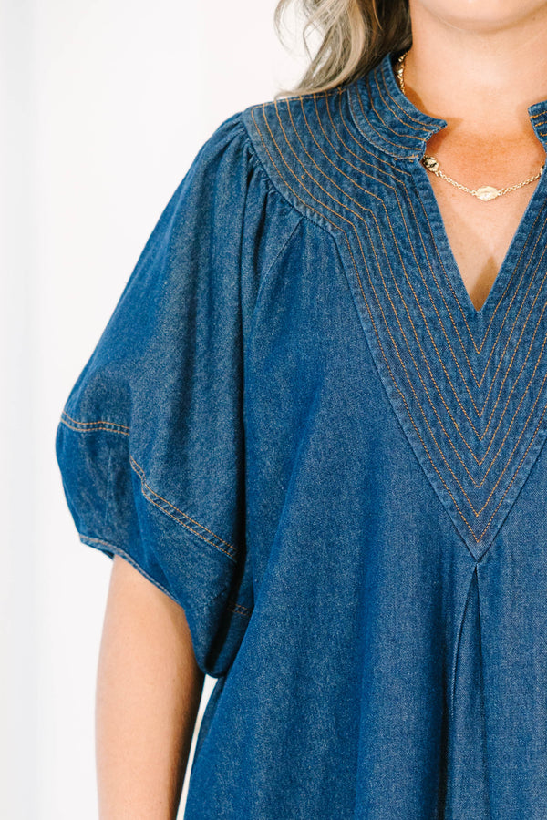 Plus Size dark denim dress with a V-neckline, decorative stitching, and short puff sleeves.