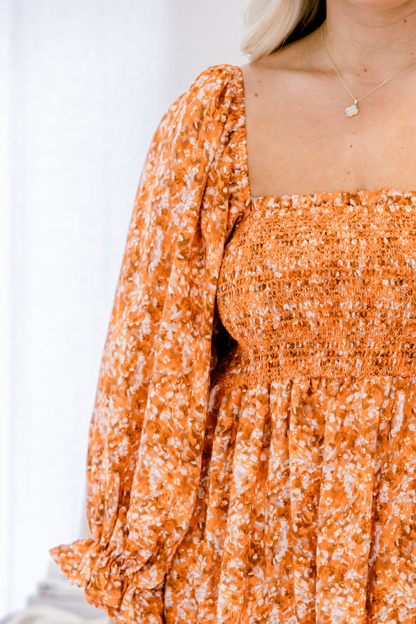 Chic Soul plus size clothing, orange floral maxi dress with long sleeves and a ruffle detail at the end of each sleeve as well as a square neckline 