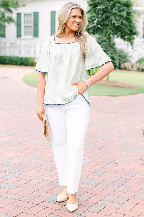 Plus Size light green floral textured top with navy scalloped trim and short flutter sleeves.