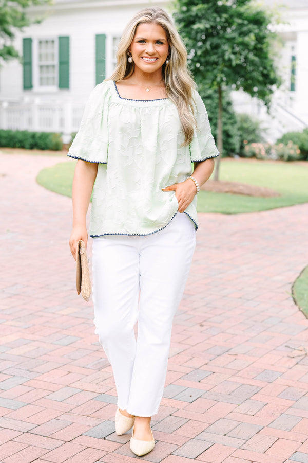 Plus Size light green floral textured top with navy scalloped trim and short flutter sleeves.