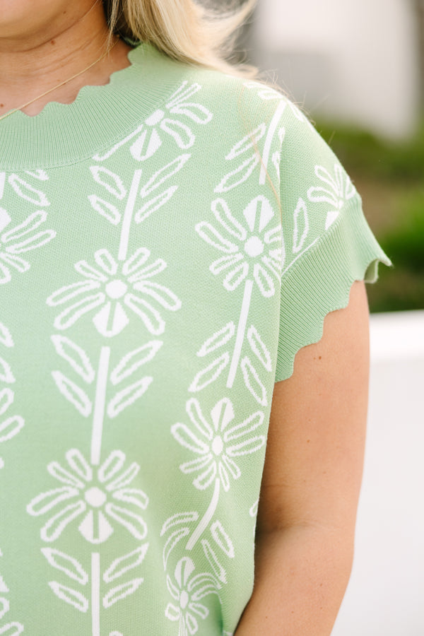 Chic Soul plus size clothing, sage sweater with short sleeves that have a scalloped look at the end of each sleeve as well as along the bottom of the sweater and along the neckline and a floral block pattern throughout the sweater 
