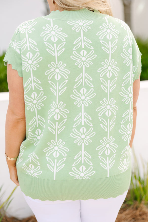 Chic Soul plus size clothing, sage sweater with short sleeves that have a scalloped look at the end of each sleeve as well as along the bottom of the sweater and along the neckline and a floral block pattern throughout the sweater 