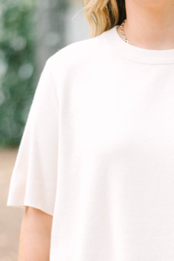 Plus Size light taupe short sleeve knit sweater with a crew neckline and ribbed trim.
