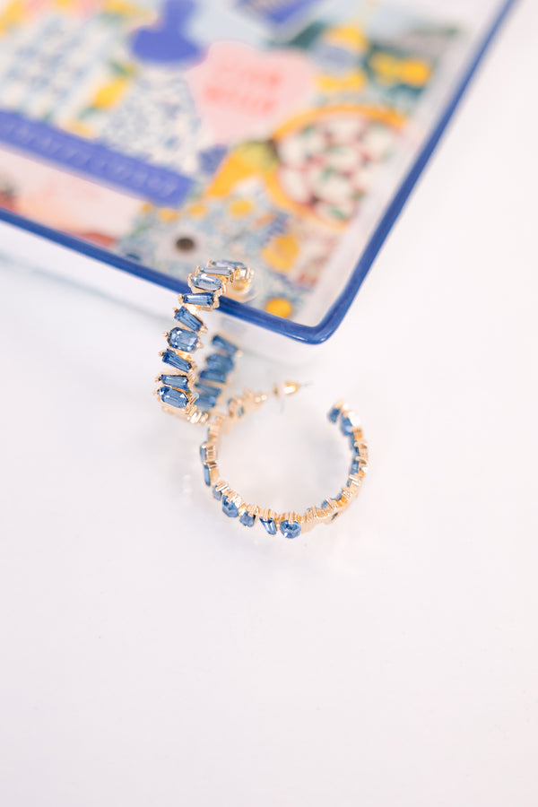 Plus Size gold hoop earrings featuring a row of rectangular blue baguette-cut crystals.