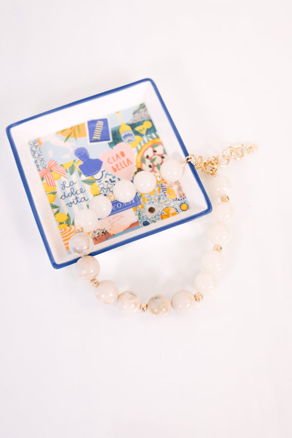 Plus Size ivory beaded necklace with gold spacers and an adjustable chain clasp.