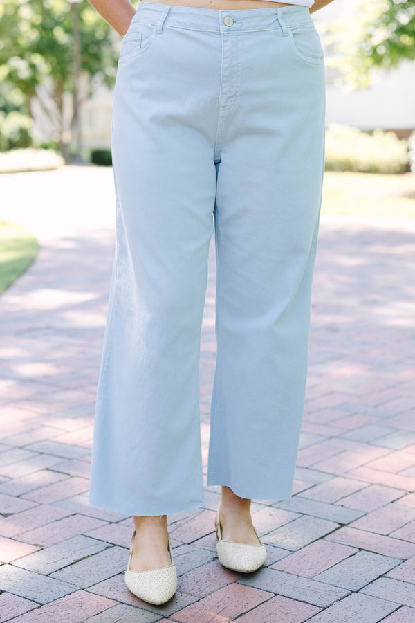 Plus Size light blue high rise crop wide leg jeans with a frayed hemline.