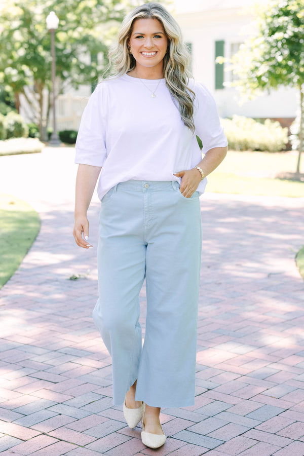 Plus Size light blue high rise crop wide leg jeans with a frayed hemline.