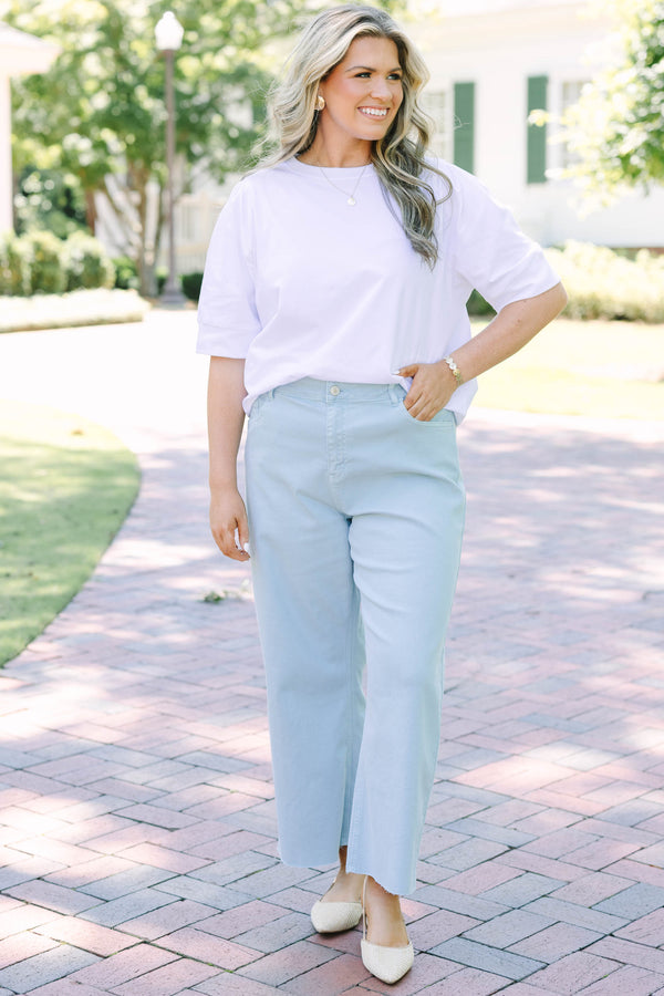 Plus Size light blue high rise crop wide leg jeans with a frayed hemline.
