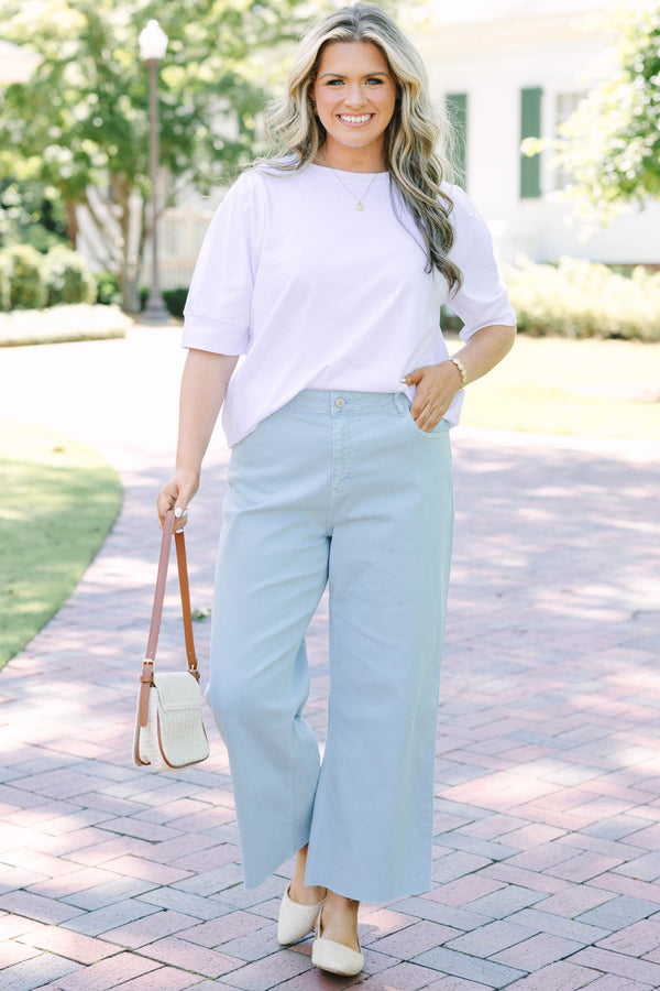 Plus Size light blue high rise crop wide leg jeans with a frayed hemline.