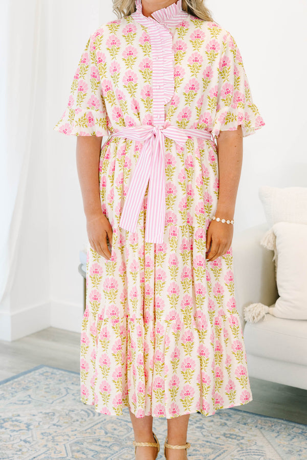 Plus size pink floral midi dress with a ruffle collar, striped waist tie, and flowy tiered skirt.