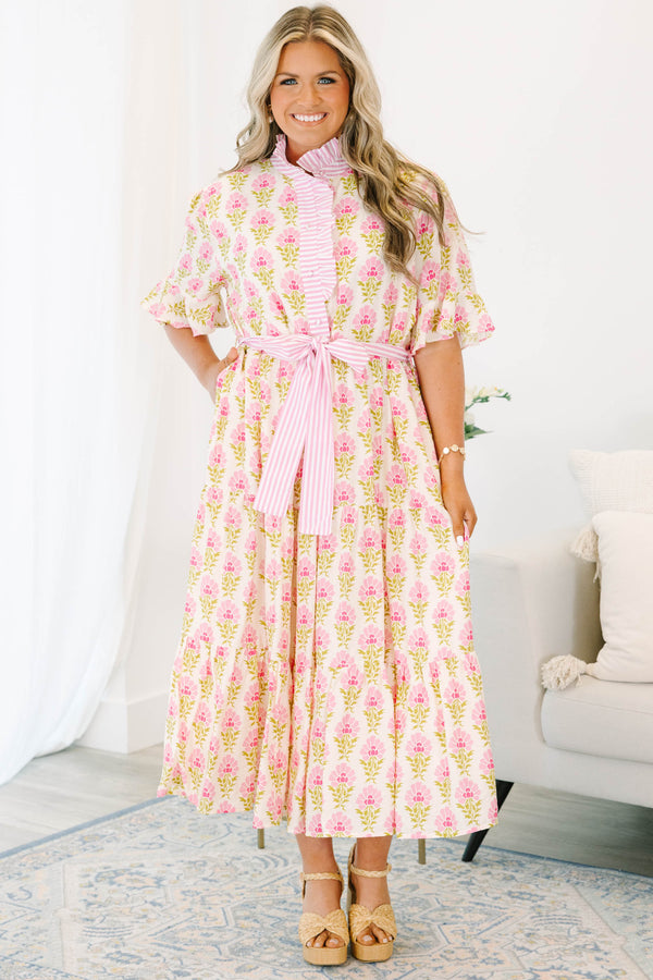 Plus size pink floral midi dress with a ruffle collar, striped waist tie, and flowy tiered skirt.