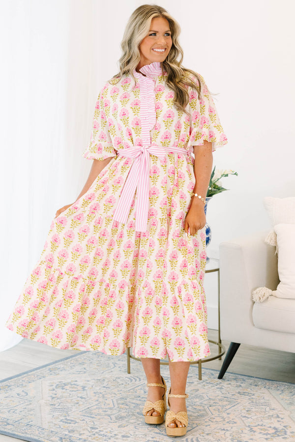 Plus size pink floral midi dress with a ruffle collar, striped waist tie, and flowy tiered skirt.